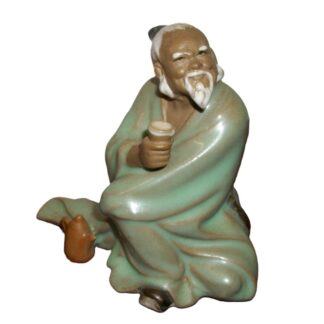 Mudman figurine drinking tea.